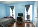 Bedroom featuring hardwood floors, blue walls and a bed with desk at 852 Glynn Oaks Dr, Clarkston, GA 30021