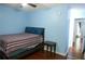 Bedroom with light blue walls, a ceiling fan, and wood-look flooring at 852 Glynn Oaks Dr, Clarkston, GA 30021