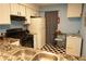 Kitchen featuring white cabinets, black appliances, checkered floors, and marble countertops at 852 Glynn Oaks Dr, Clarkston, GA 30021