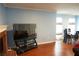 Bright living room showcasing hardwood floors, a brick fireplace, and a dining area with a glass table and chairs at 852 Glynn Oaks Dr, Clarkston, GA 30021