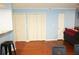 Living area featuring hardwood floors and white trim, with a partial view of the kitchen counter at 852 Glynn Oaks Dr, Clarkston, GA 30021