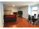 Bright living area with hardwood floors, fireplace, and a dining table at 852 Glynn Oaks Dr, Clarkston, GA 30021