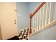Staircase view featuring checkered accents and a wooden railing at 852 Glynn Oaks Dr, Clarkston, GA 30021