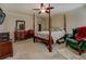 Bedroom featuring a four-poster bed, dresser, and ample closet space at 110 Baltusrol Way, Covington, GA 30014