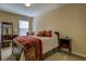 Cozy bedroom featuring a decorative vanity, comfortable chair, and plush carpet at 110 Baltusrol Way, Covington, GA 30014