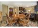 Cozy dining area features a round wooden table, four chairs, and a patterned rug at 110 Baltusrol Way, Covington, GA 30014