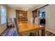 Formal dining room featuring chandelier, hardwood floors, and an adjacent view into the kitchen at 110 Baltusrol Way, Covington, GA 30014