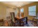 Formal dining room featuring chandelier, hardwood floors, and an adjacent view into the living room at 110 Baltusrol Way, Covington, GA 30014
