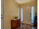 Bright entryway featuring hardwood floors, a white door, and a stylish dresser with marble top at 110 Baltusrol Way, Covington, GA 30014