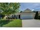 Charming single-story home with a well-manicured lawn, inviting curb appeal, and a two-car garage at 110 Baltusrol Way, Covington, GA 30014