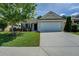 Home featuring a two-car garage, driveway, and manicured front lawn at 110 Baltusrol Way, Covington, GA 30014