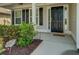 Inviting front entrance with black door, sidelights, shutters, and landscaped garden at 110 Baltusrol Way, Covington, GA 30014
