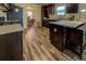 Spacious kitchen with wood floors and cabinets, view to dining room and stainless steel appliances at 110 Baltusrol Way, Covington, GA 30014
