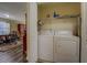 Laundry room featuring a new washer and dryer with shelving at 110 Baltusrol Way, Covington, GA 30014
