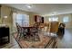 Open-concept living area features a dining area, hardwood floors, and natural light at 110 Baltusrol Way, Covington, GA 30014