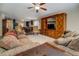 Open-concept living room with decorative wood entertainment center and plush seating at 110 Baltusrol Way, Covington, GA 30014