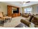Comfortable living room with a decorative wood entertainment center and plush seating at 110 Baltusrol Way, Covington, GA 30014