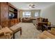 Spacious living room featuring plush seating and decorative wood entertainment center at 110 Baltusrol Way, Covington, GA 30014