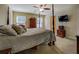 Spacious bedroom with a four-poster bed, ceiling fan, and mounted flat screen TV at 110 Baltusrol Way, Covington, GA 30014