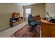 Office space with a desk, chair, shelving, and a patterned rug at 110 Baltusrol Way, Covington, GA 30014