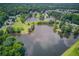 Aerial view showcasing the neighborhood's well-maintained landscaping, community pond, and residential homes at 1721 Crowes Lake Ct, Lawrenceville, GA 30043