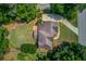 Aerial view showcasing the home's roof, driveway, landscaping, and backyard at 1721 Crowes Lake Ct, Lawrenceville, GA 30043