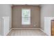 Attic space featuring neutral carpet, a window and closet access at 1721 Crowes Lake Ct, Lawrenceville, GA 30043