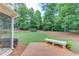 Spacious backyard with a wooden deck and bench seating perfect for outdoor gatherings at 1721 Crowes Lake Ct, Lawrenceville, GA 30043