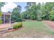 Expansive backyard featuring lush lawn and a deck overlooking well-maintained landscaping at 1721 Crowes Lake Ct, Lawrenceville, GA 30043