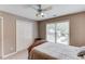 Comfortable bedroom featuring a ceiling fan, a window and a closet with double doors at 1721 Crowes Lake Ct, Lawrenceville, GA 30043