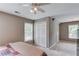 Upstairs bedroom space with neutral carpet, a ceiling fan and access to attic storage at 1721 Crowes Lake Ct, Lawrenceville, GA 30043