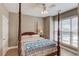 Bedroom features a four-poster bed, natural light, and neutral decor for a serene retreat at 1721 Crowes Lake Ct, Lawrenceville, GA 30043