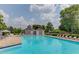 Community pool featuring ample lounge chairs and umbrellas for relaxing by the water at 1721 Crowes Lake Ct, Lawrenceville, GA 30043