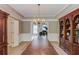 Elegant dining room featuring a chandelier, hardwood floors, and custom built-ins for sophisticated entertaining at 1721 Crowes Lake Ct, Lawrenceville, GA 30043