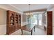 Dining room features hardwood floors, a large wooden table, a chandelier, and natural light at 1721 Crowes Lake Ct, Lawrenceville, GA 30043