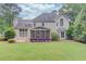 Beautiful home exterior with a screened porch, a deck, and a well-manicured backyard at 1721 Crowes Lake Ct, Lawrenceville, GA 30043