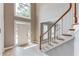 Open foyer with light wood floors, staircase with wood railing and large window for natural light at 1721 Crowes Lake Ct, Lawrenceville, GA 30043