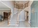 Inviting home foyer featuring a staircase, light wood floors, and large windows for natural light at 1721 Crowes Lake Ct, Lawrenceville, GA 30043