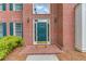 Close-up of brick home's front door with sidelights, traditional fixtures, and surrounding landscaping at 1721 Crowes Lake Ct, Lawrenceville, GA 30043