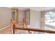 Hallway with wood railing, neutral walls, and chandelier at 1721 Crowes Lake Ct, Lawrenceville, GA 30043