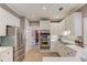 Modern kitchen featuring stainless steel appliances, white cabinets, and an open layout at 1721 Crowes Lake Ct, Lawrenceville, GA 30043