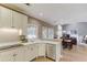 Open kitchen featuring stainless appliances, white cabinets, and views to dining area and living room at 1721 Crowes Lake Ct, Lawrenceville, GA 30043