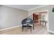 Living room with hardwood floors, a piano, and built in shelving with open access to dining room at 1721 Crowes Lake Ct, Lawrenceville, GA 30043