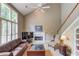 Bright living room with high ceilings, fireplace, large windows, and staircase access at 1721 Crowes Lake Ct, Lawrenceville, GA 30043