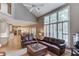 Spacious living room with hardwood floors, large windows, and view into an open kitchen and breakfast area at 1721 Crowes Lake Ct, Lawrenceville, GA 30043
