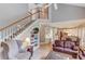 Open living room with a staircase, built-in shelving, and a view of the kitchen and breakfast area at 1721 Crowes Lake Ct, Lawrenceville, GA 30043