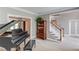 Spacious living room with hardwood floors, a piano, built in shelving, and staircase at 1721 Crowes Lake Ct, Lawrenceville, GA 30043