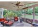 Inviting screened porch with wicker furniture, ceiling fan, and views of the landscaped backyard at 1721 Crowes Lake Ct, Lawrenceville, GA 30043