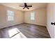 Bright bedroom with wood-look flooring, ceiling fan and double windows at 2535 Impala Dr, Cumming, GA 30041