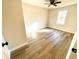 View of a bedroom with light-colored walls, hardwood floors, and a ceiling fan at 2535 Impala Dr, Cumming, GA 30041